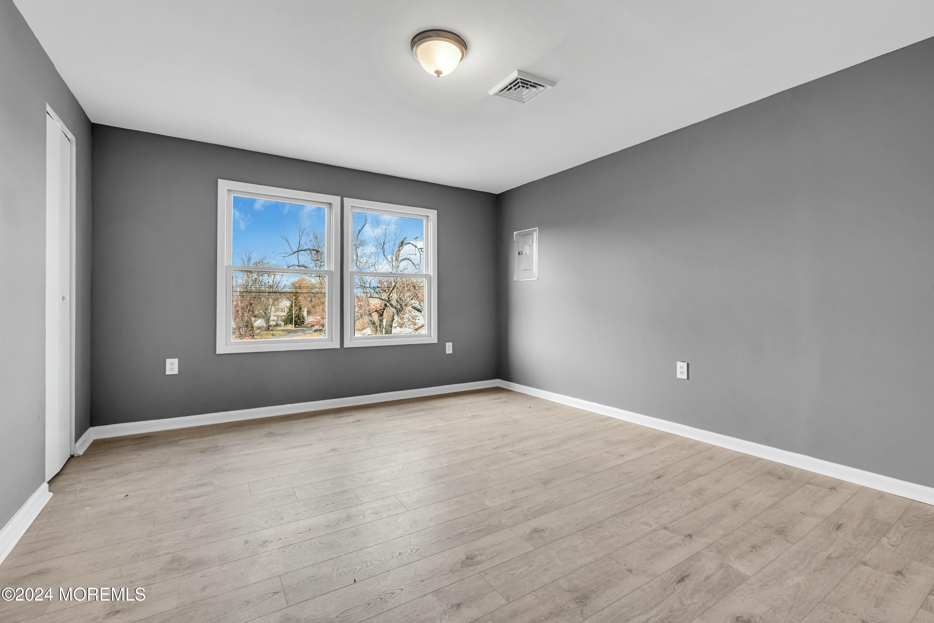 211 Delaware Avenue, Unit 2 Cliffwood, NJ 07721 - Photo 12 of 16 an empty room with windows and closet