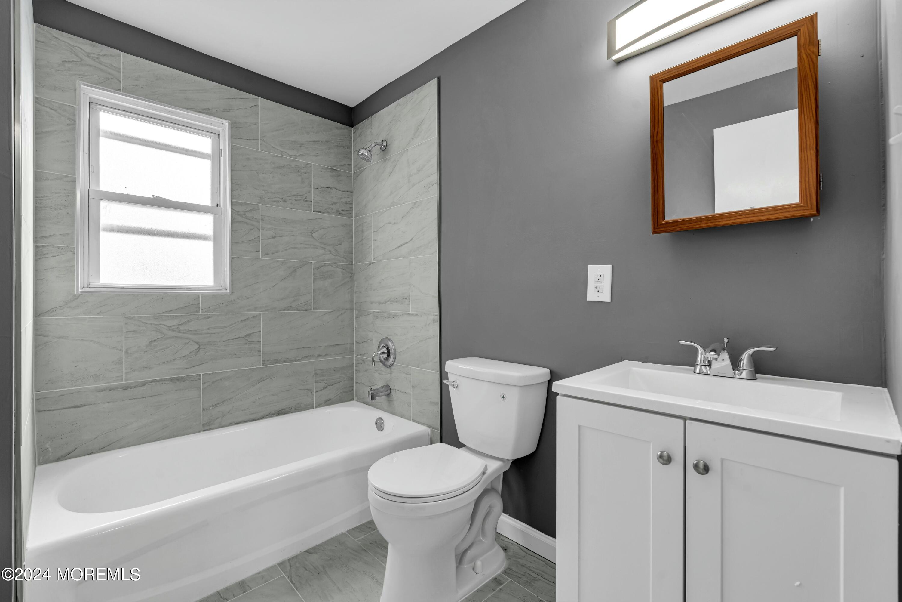 211 Delaware Avenue, Unit 2 Cliffwood, NJ 07721 - Photo 13 of 16 a bathroom with a sink toilet and bathtub