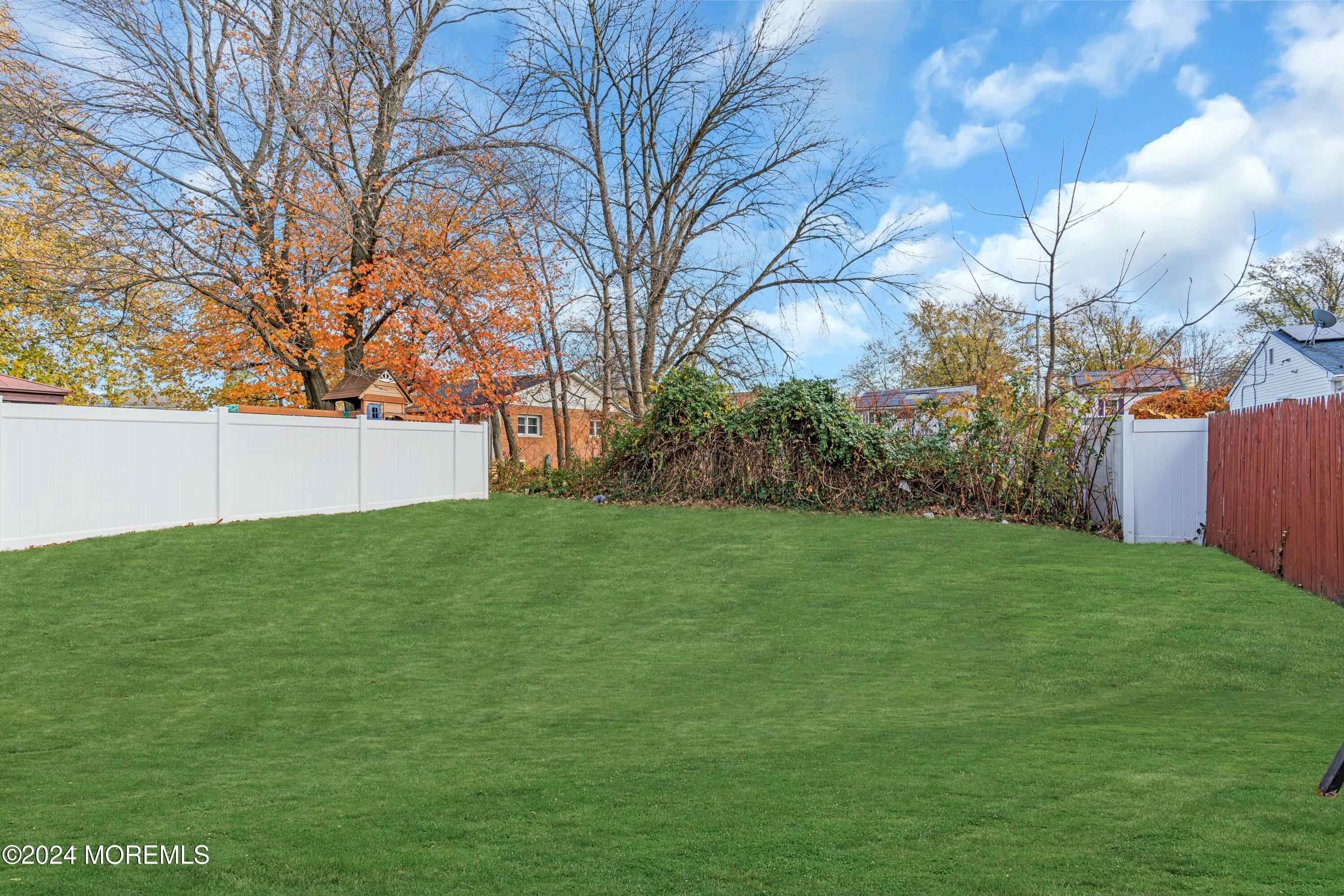 211 Delaware Avenue, Unit 2 Cliffwood, NJ 07721 - Photo 14 of 16 a view of a backyard with large trees