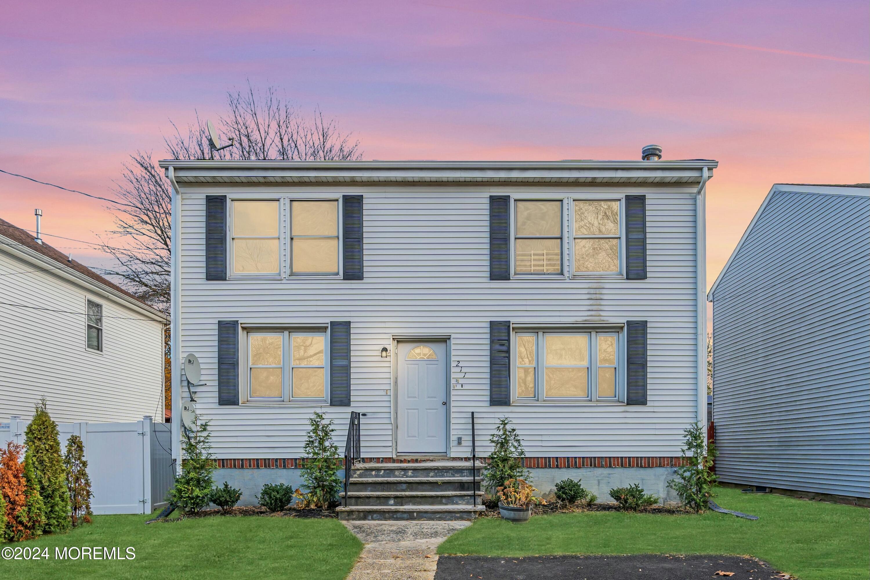 211 Delaware Avenue, Unit 2 Cliffwood, NJ 07721 - Photo 2 of 16 a front view of a house with a garden and plants