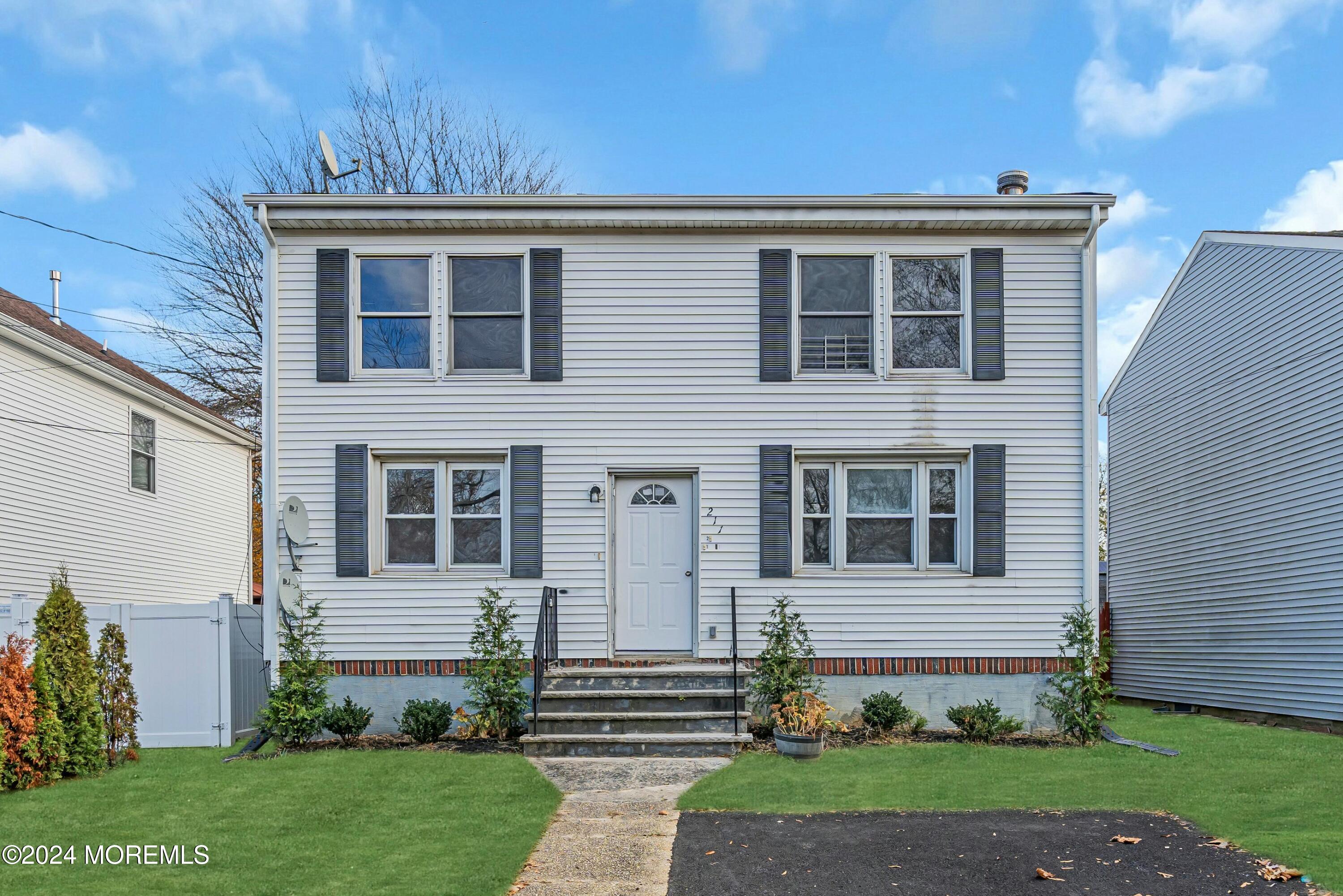 211 Delaware Avenue, Unit 2 Cliffwood, NJ 07721 - Photo 3 of 16 a front view of a house with a yard