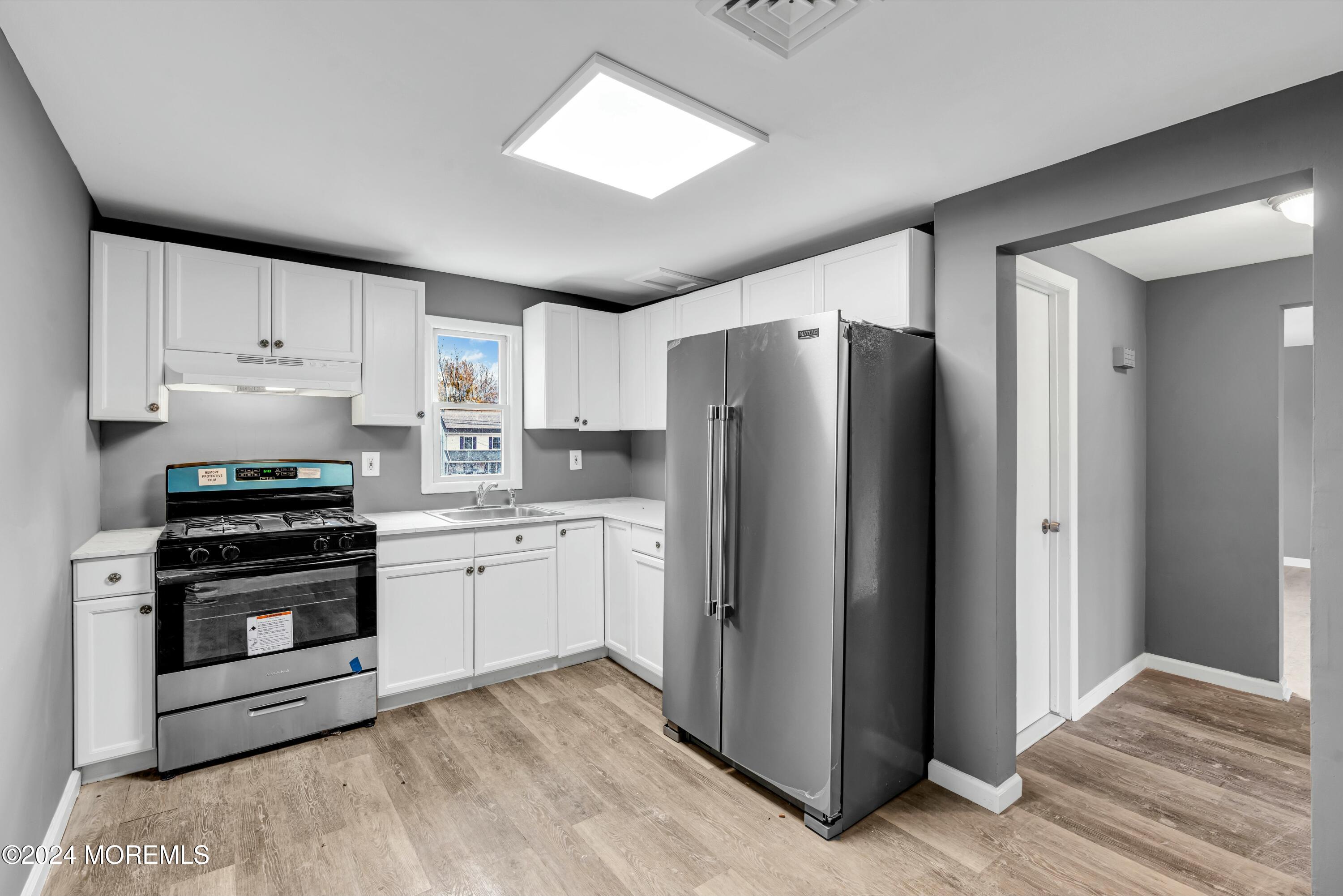 211 Delaware Avenue, Unit 2 Cliffwood, NJ 07721 - Photo 9 of 16 a kitchen with stainless steel appliances a refrigerator stove and sink