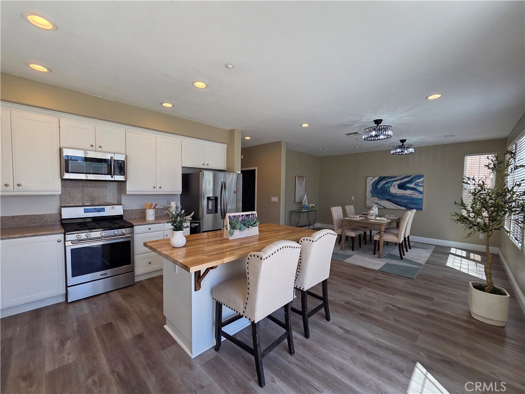 20329 Red Poppy Lane Riverside, CA 92508 - Photo 12 of 24 a large kitchen with a table and chairs in it