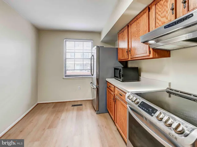 a kitchen with stainless steel appliances granite countertop a stove sink and cabinets
