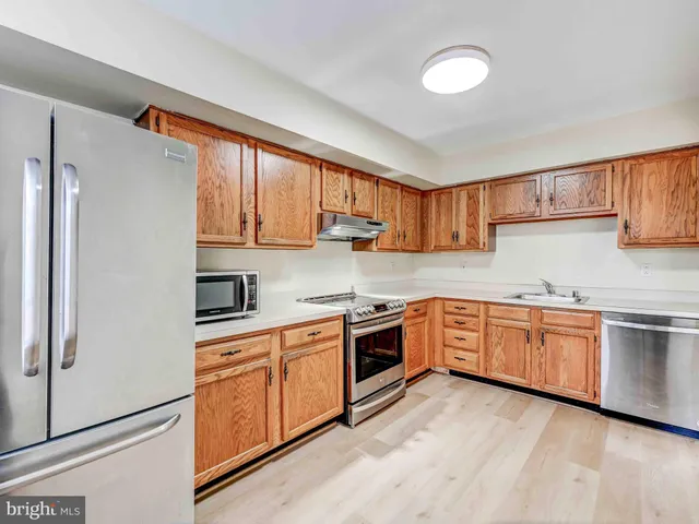 a view of a hallway with wooden floor and entryway