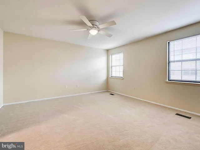 a bathroom with a granite countertop toilet and a sink