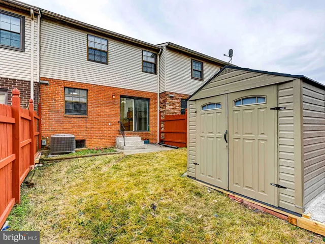 front view of a brick house with a yard