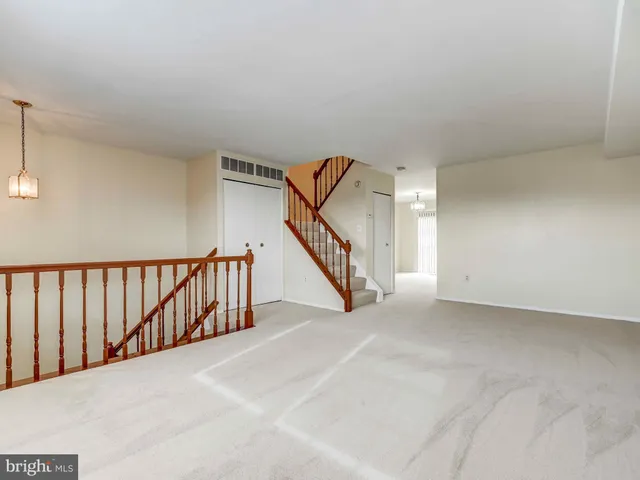 a view of an empty room with stairs