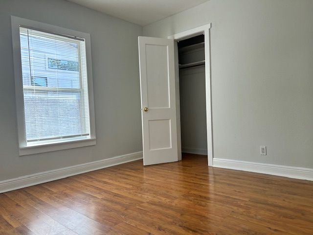 5513 Woodrow Avenue Austin, TX 78756 - Photo 11 of 17 an empty room with wooden floor and windows
