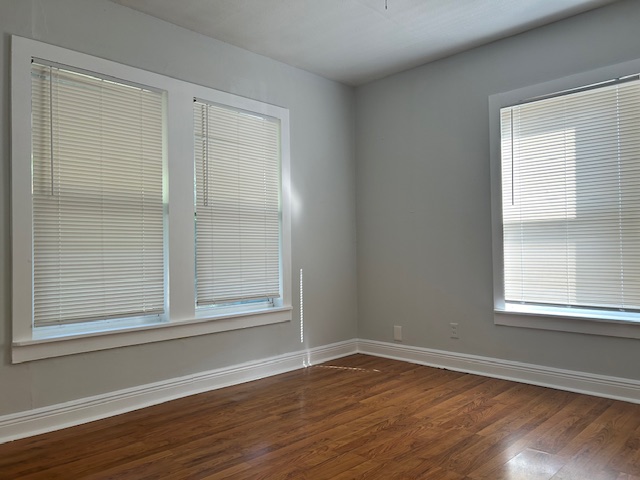 5513 Woodrow Avenue Austin, TX 78756 - Photo 12 of 17 a view of an empty room with wooden floor and a window