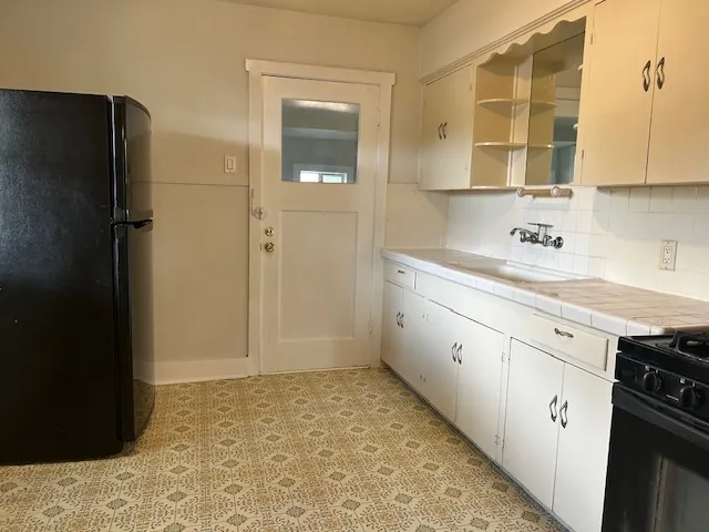 a kitchen with a refrigerator and a sink