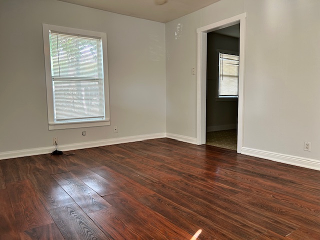5513 Woodrow Avenue Austin, TX 78756 - Photo 5 of 17 an empty room with wooden floor and windows