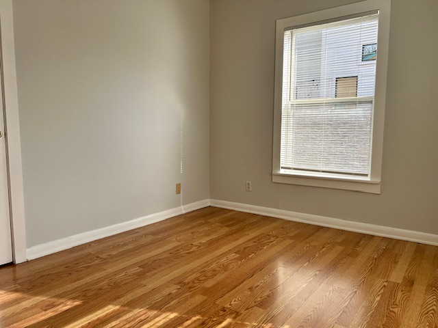 5513 Woodrow Avenue Austin, TX 78756 - Photo 8 of 17 an empty room with wooden floor and windows