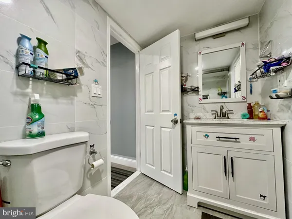a bathroom with a sink mirror vanity and toilet