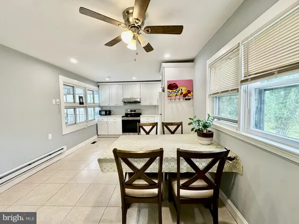 a dining room with furniture and window