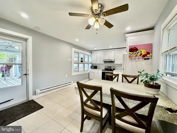 a view of a dining room with furniture and a chandelier fan