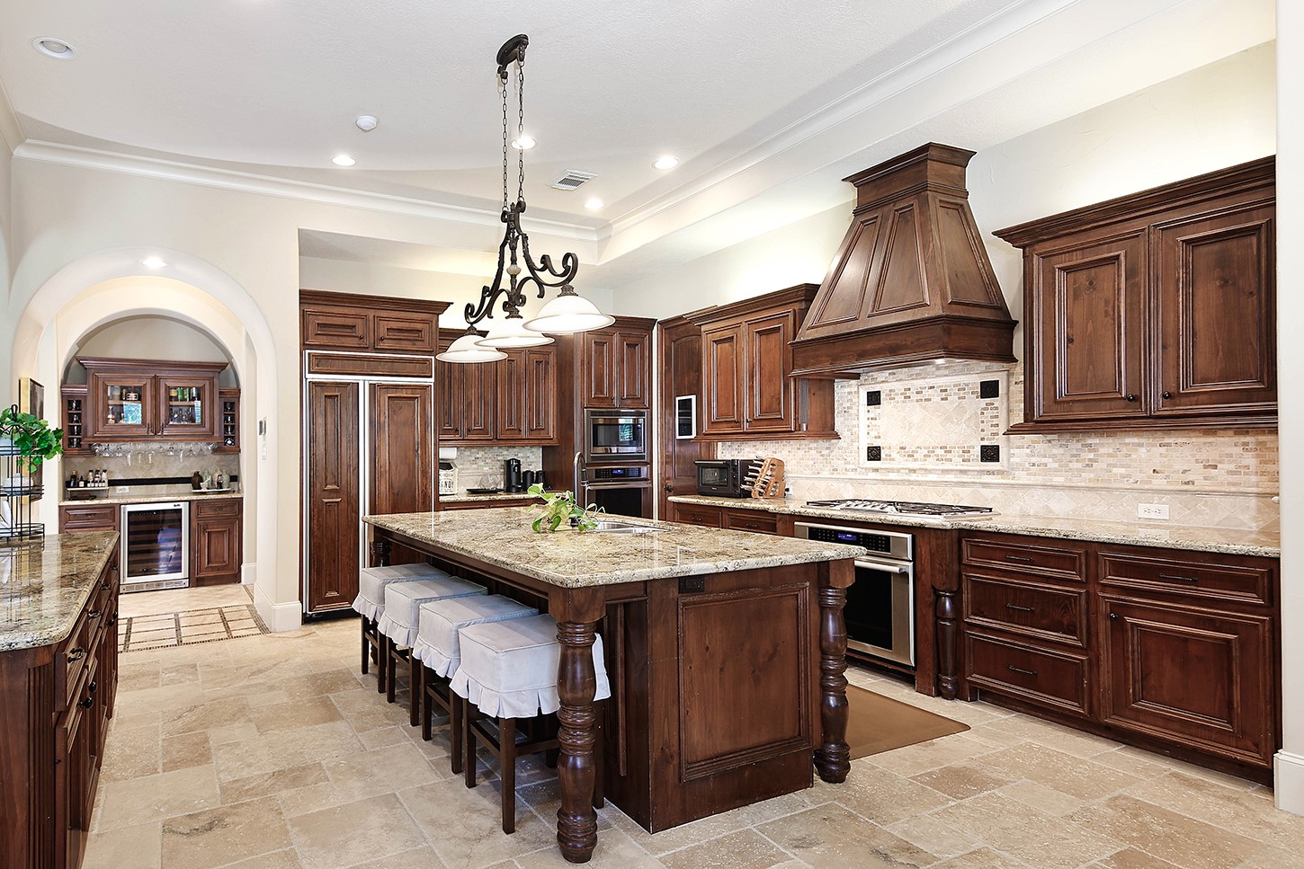 119 Angel Leaf Road The Woodlands, TX 77380 - Photo 15 of 50 a kitchen with kitchen island granite countertop a center island a stove and a chandelier