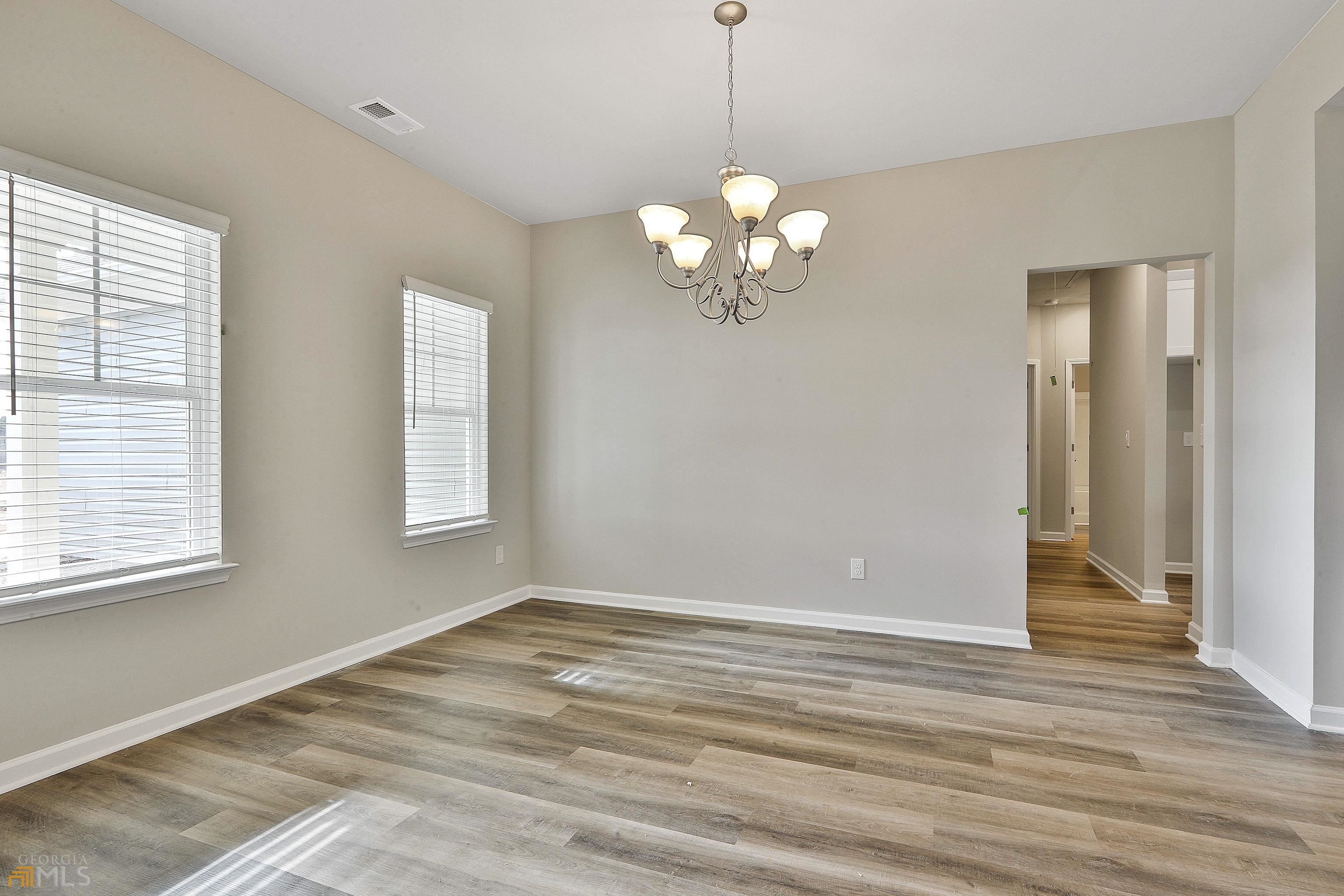 3575 Strickland Town Road Luthersville, GA 30251 - Photo 11 of 29 a view of an empty room with wooden floor and a window