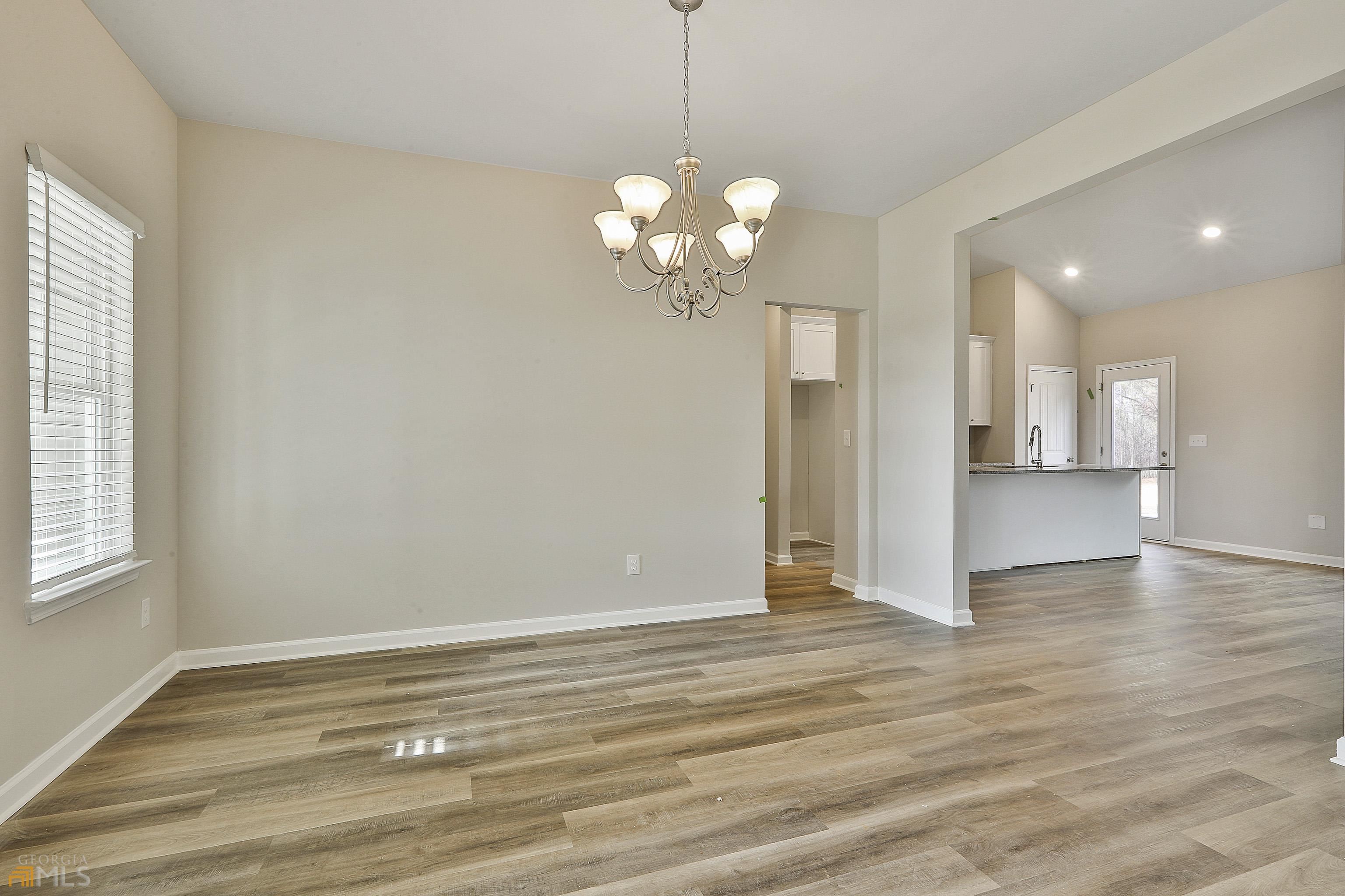 3575 Strickland Town Road Luthersville, GA 30251 - Photo 12 of 29 a view of an empty room with window and wooden floor
