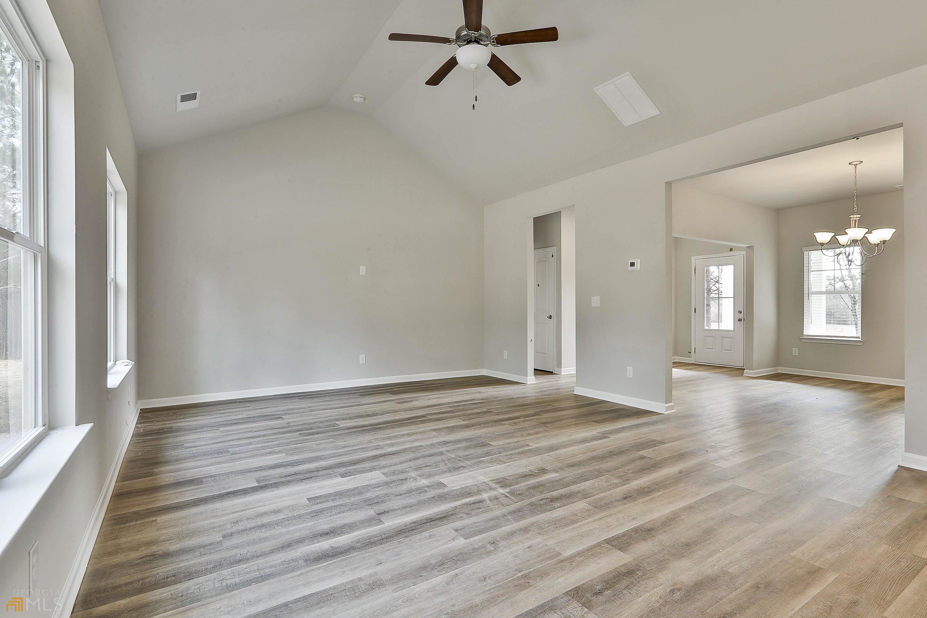 3575 Strickland Town Road Luthersville, GA 30251 - Photo 15 of 29 an empty room with wooden floor and windows