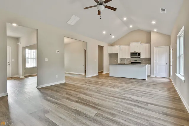 a view of a kitchen with a sink and a refrigerator