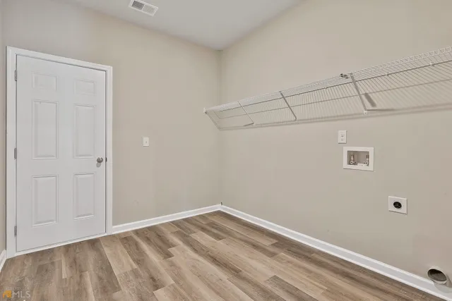 a view of a room with wooden floor