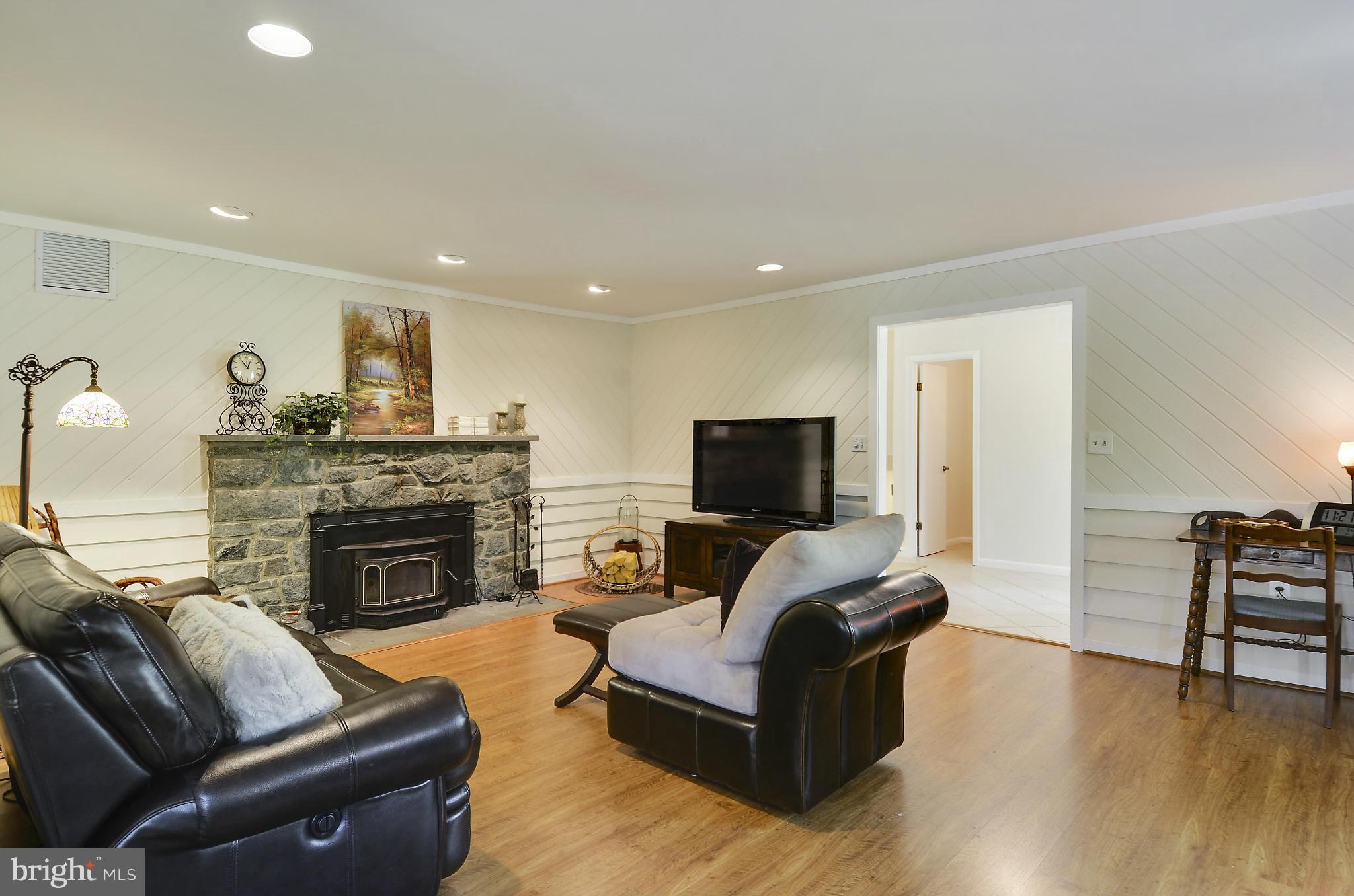 21013 Sunnyacres Road Gaithersburg, MD 20882 - Photo 11 of 30 a living room with furniture a fireplace and a flat screen tv