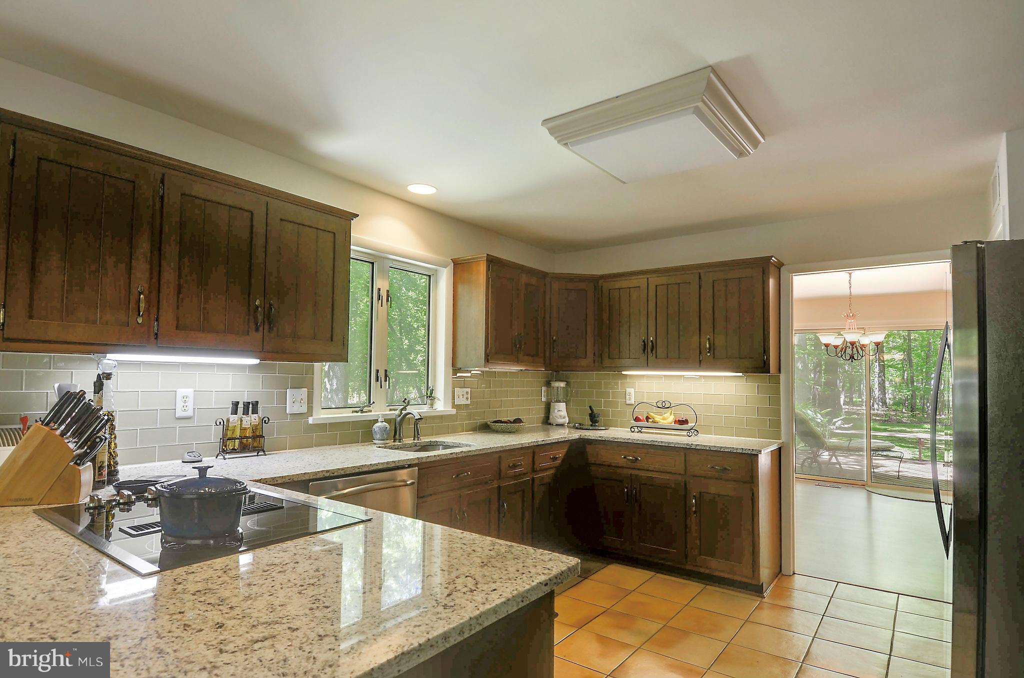 21013 Sunnyacres Road Gaithersburg, MD 20882 - Photo 13 of 30 a kitchen with a sink stove and cabinets