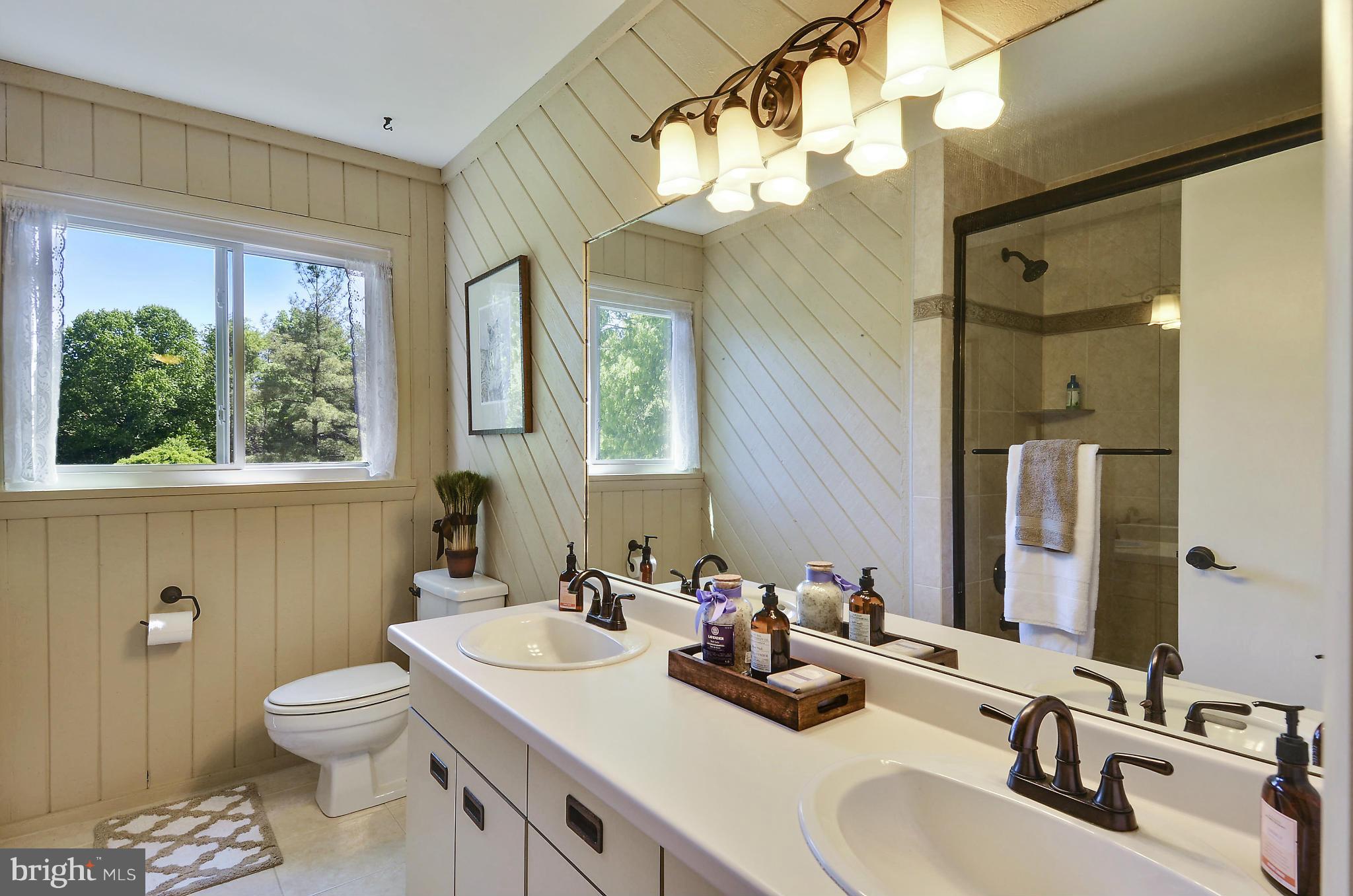 21013 Sunnyacres Road Gaithersburg, MD 20882 - Photo 22 of 30 a bathroom with a toilet a sink and a mirror