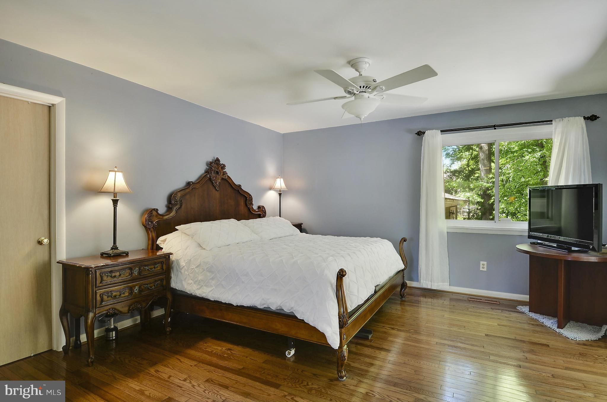 21013 Sunnyacres Road Gaithersburg, MD 20882 - Photo 23 of 30 a bedroom with a bed and a flat screen tv