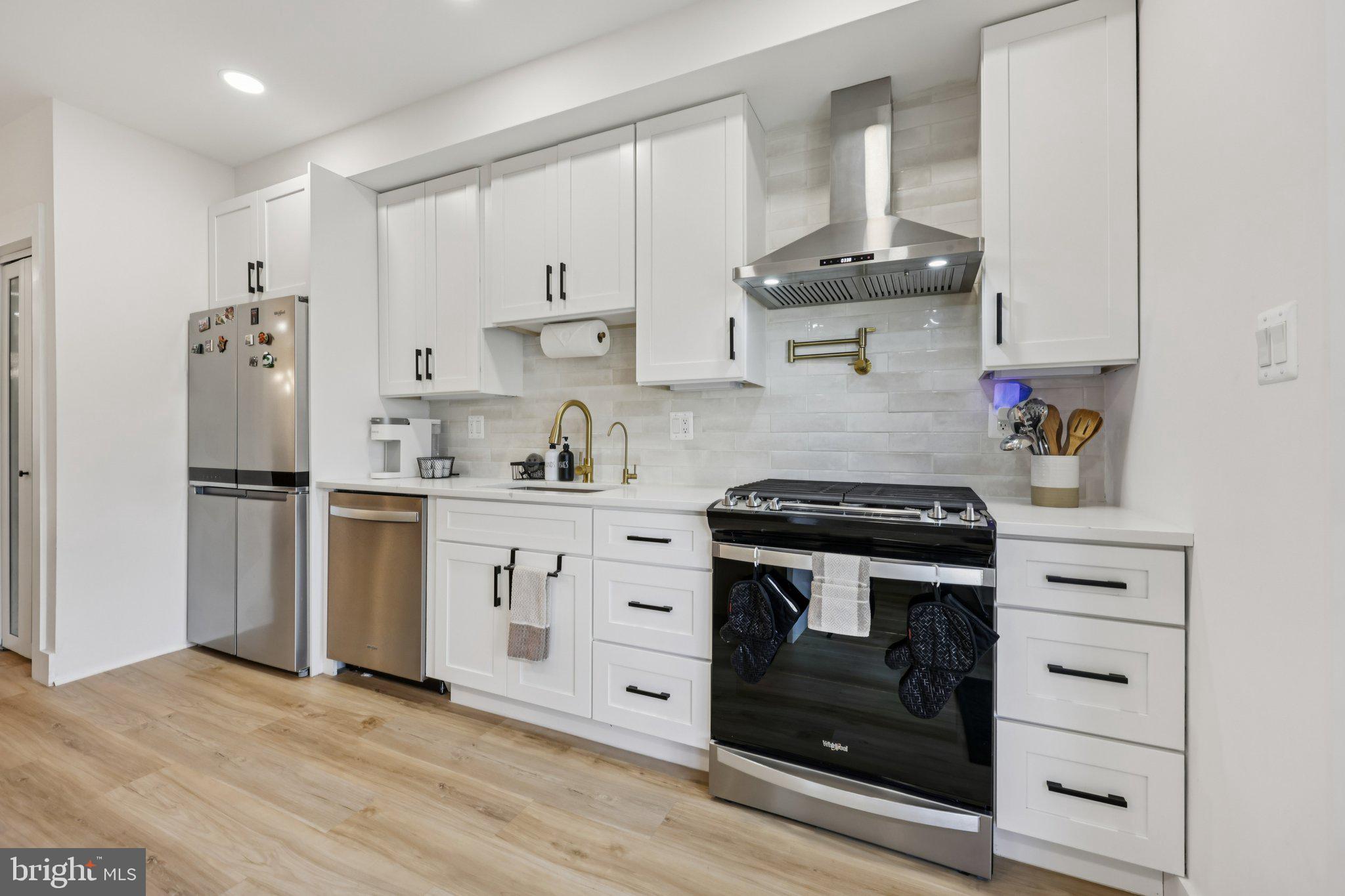 2604 4th Street Northeast Washington, DC 20002 - Photo 13 of 41 a kitchen with stainless steel appliances a stove and a refrigerator