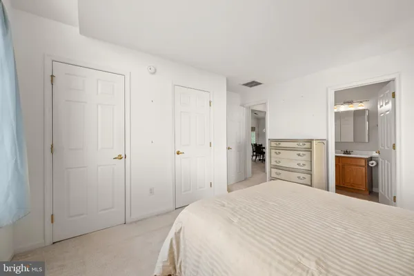 a bedroom with a bed and a bathroom