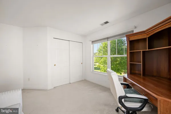 a room with a chair and a window
