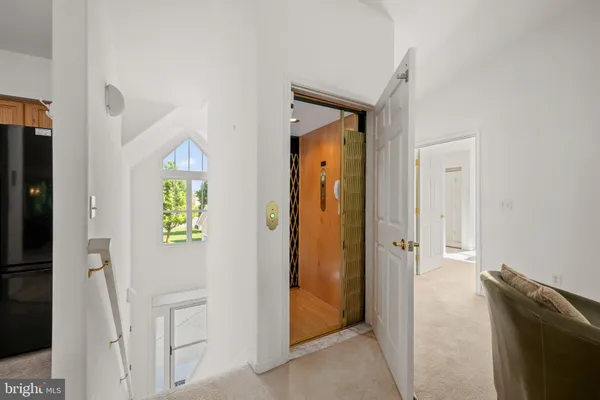 hallway with wooden floor and windows