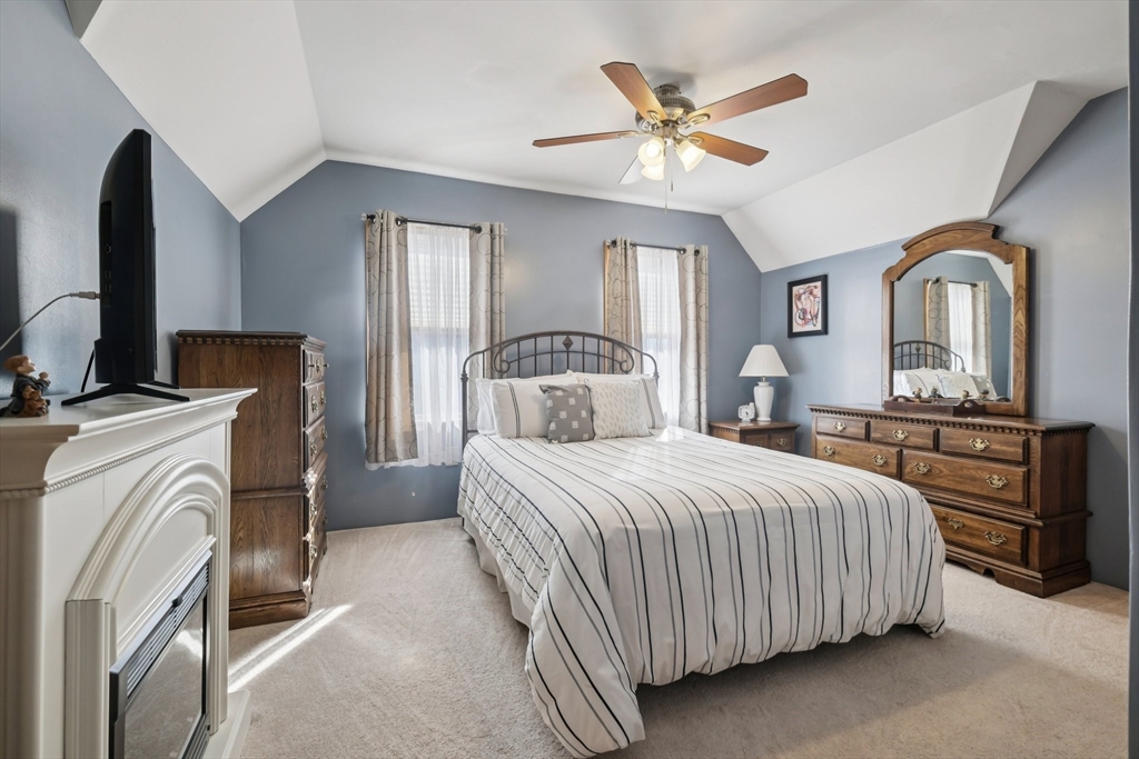 39-41 Kinsman Street Everett, MA 02149 - Photo 25 of 37 a bedroom with a large bed and a flat tv screen