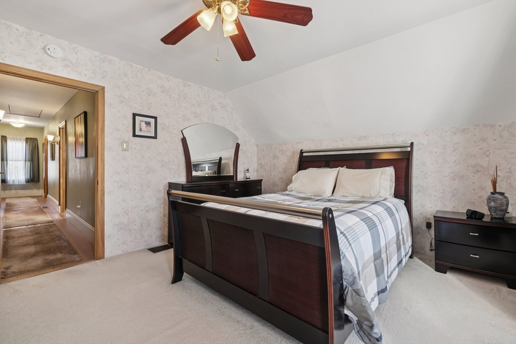 39-41 Kinsman Street Everett, MA 02149 - Photo 28 of 37 a bedroom with a bed and a chandelier