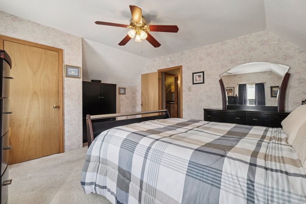 39-41 Kinsman Street Everett, MA 02149 - Photo 29 of 37 a bedroom with a bed and a chandelier