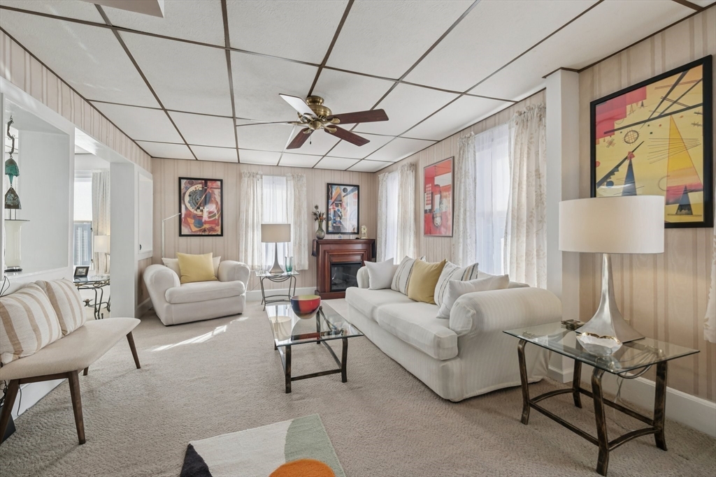 39-41 Kinsman Street Everett, MA 02149 - Photo 10 of 37 a living room with furniture a ceiling fan a rug and a window