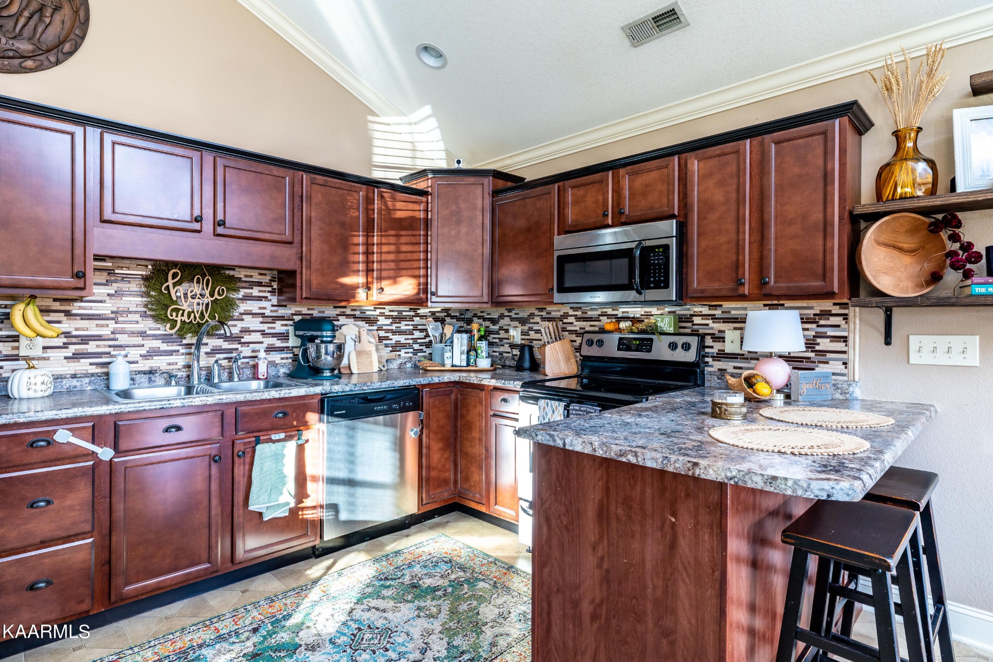 6030 Whisper Ridge Lane Corryton, TN 37721 - Photo 17 of 30 a kitchen with granite countertop wooden cabinets a stove top oven a granite counter space and a window