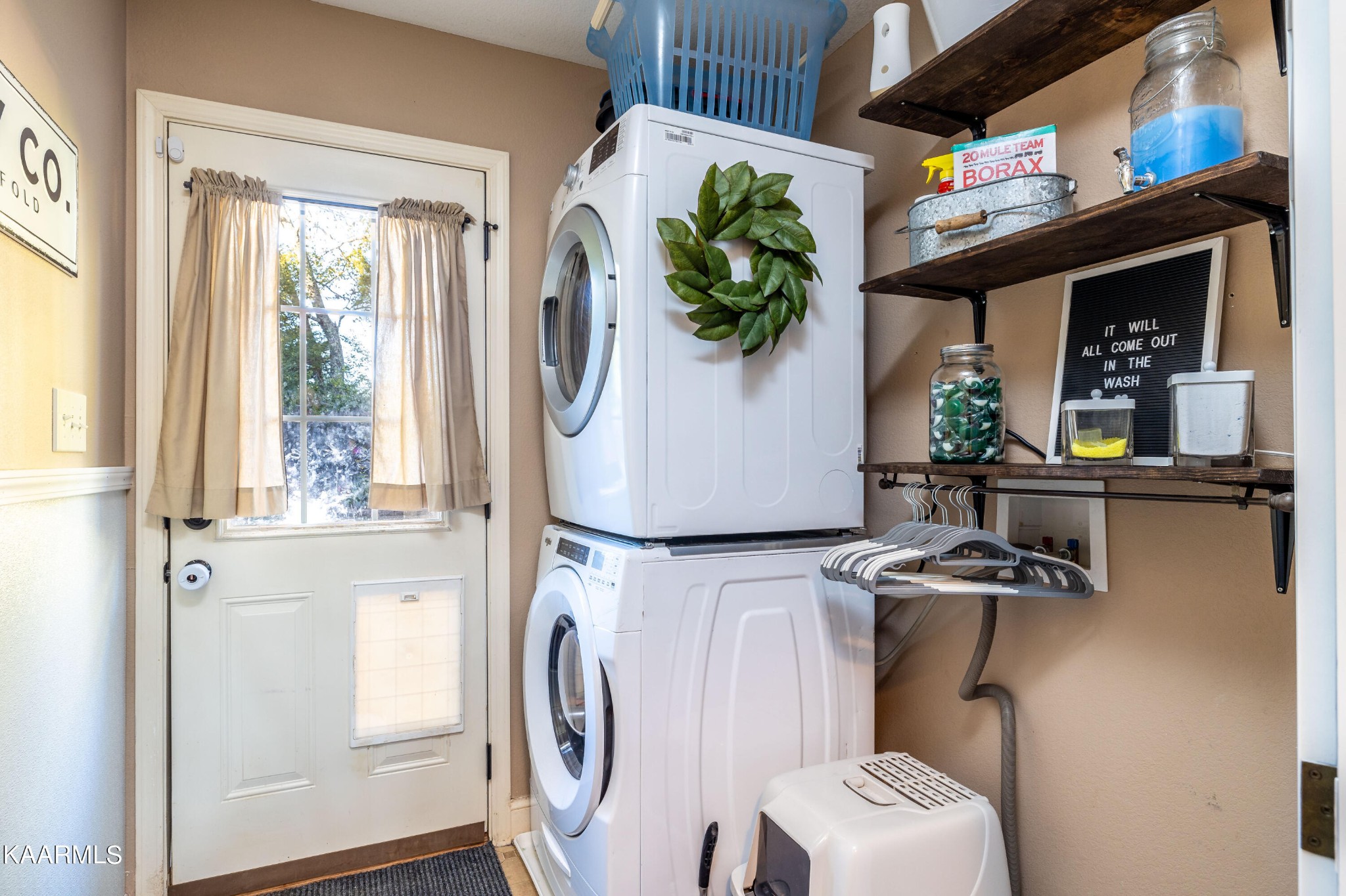 6030 Whisper Ridge Lane Corryton, TN 37721 - Photo 23 of 30 a view of washer and dryer with bathroom in the background