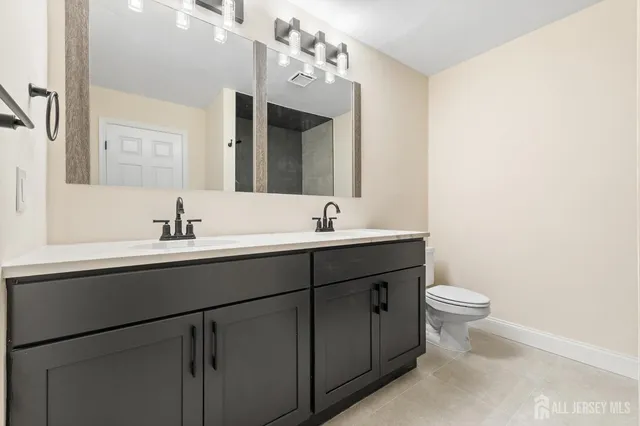 an empty room with wooden floor ceiling fan and windows