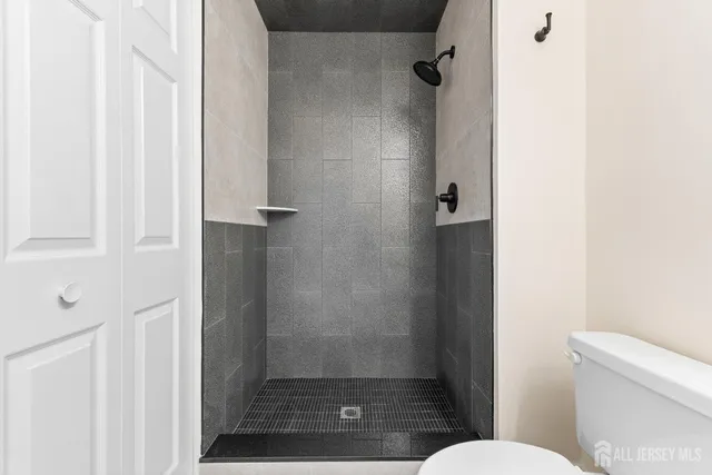 an aerial view of a swimming pool with a yard and lake view