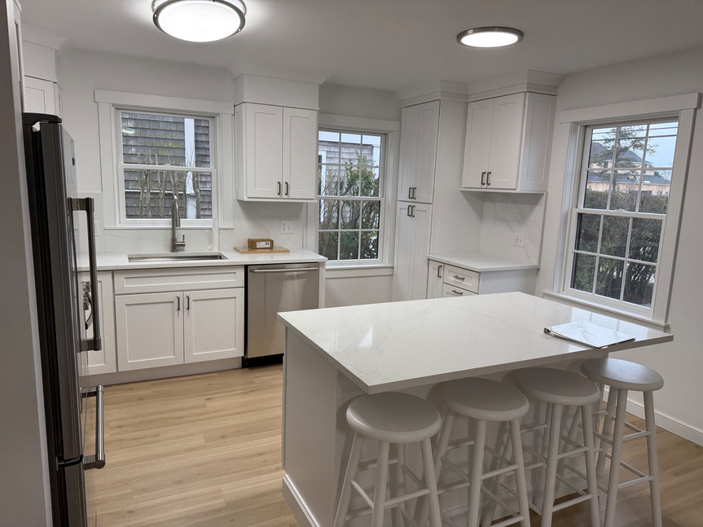 106 Old South Road, Unit A B Nantucket, MA 02554 - Photo 6 of 24 a kitchen with a table chairs sink refrigerator and cabinets