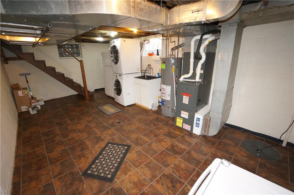 890 Middle Road Castle Shannon, PA 15234 - Photo 22 of 25 Basement w tiled floor...even the laundry tray is attractive Front loaders are included Furnace has air cleaner Note interior french drain w sump pump