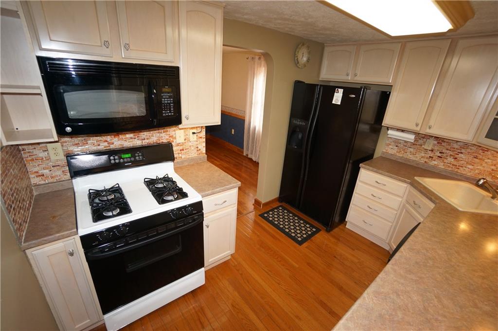 890 Middle Road Castle Shannon, PA 15234 - Photo 7 of 25 The cabinet to R of gas stove has pull out shelving for pots & pans