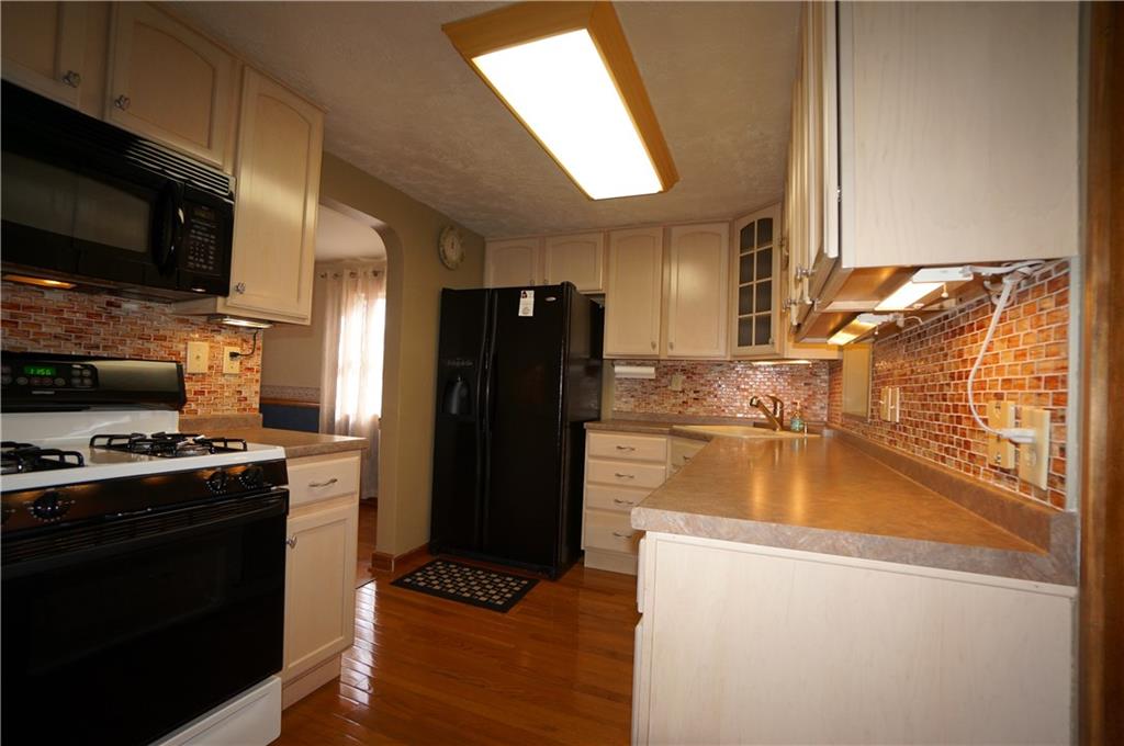 890 Middle Road Castle Shannon, PA 15234 - Photo 8 of 25 Lots of lighting...overhead and under cabinet...glass wall tile sparkles....