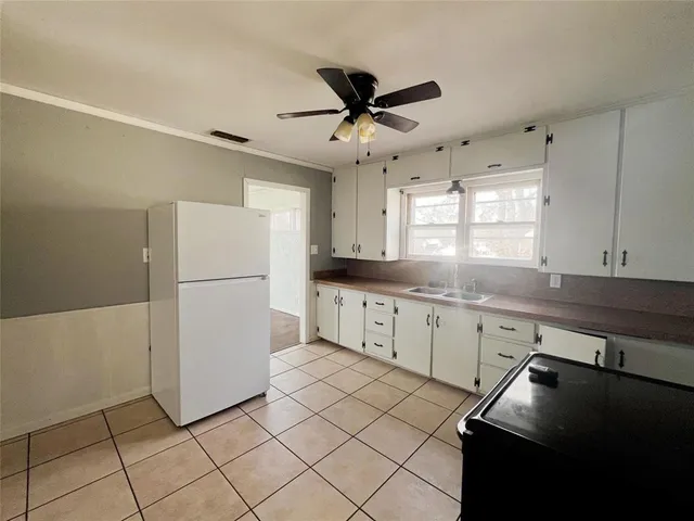 a kitchen with a refrigerator a sink dishwasher and cabinets