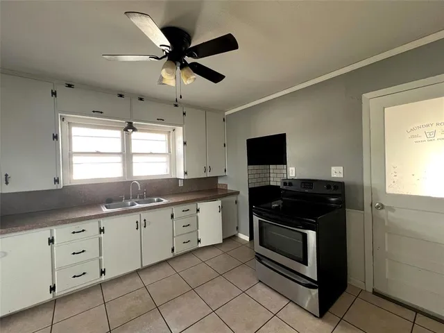 a kitchen with granite countertop a sink and appliances