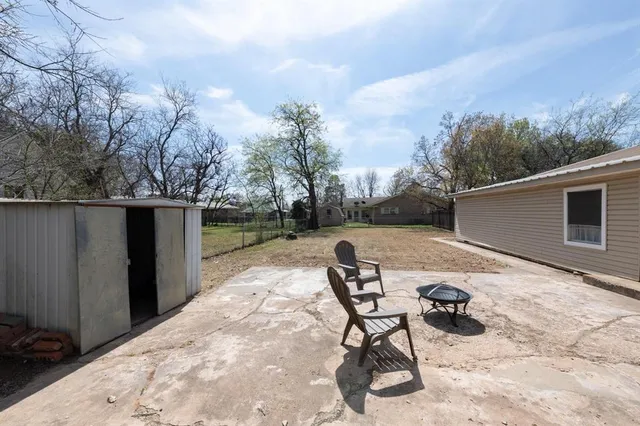 a backyard of a house with table and chairs