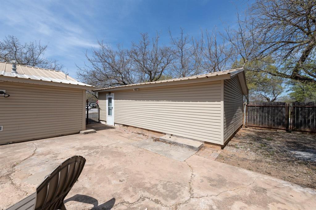 402 South Red River Street Henrietta, TX 76365 - Photo 8 of 20 a view of backyard with cabin and wooden fencing